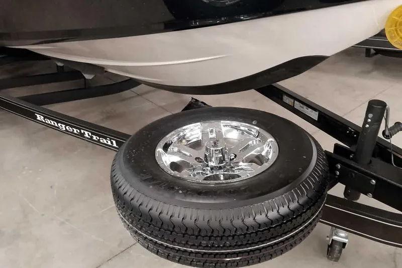 Slide: The Image of 2026 Ranger 2050MS Reata boat trailer with spare tire and chrome wheel. - 43