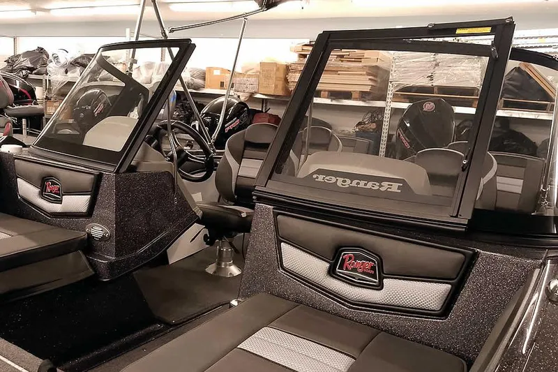 Slide: The Image of 2026 Ranger 2050MS Reata boat interior with dual consoles and seating. - 7