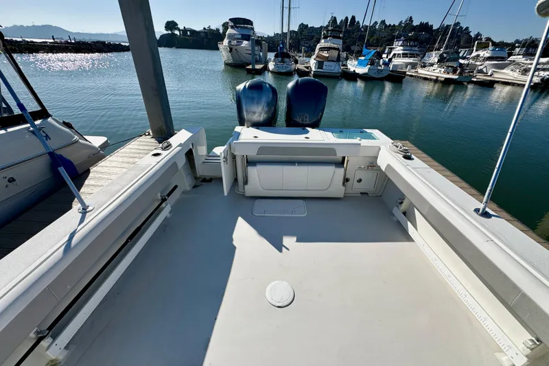 Slide: The Image of 2021 Parker 2820 XLD Sport Cabin boat docked at marina, spacious deck view. - 11