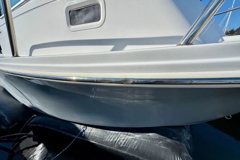Slide: The Image of 2021 Parker 2820 XLD Sport Cabin boat hull with chrome detailing and window. - 16