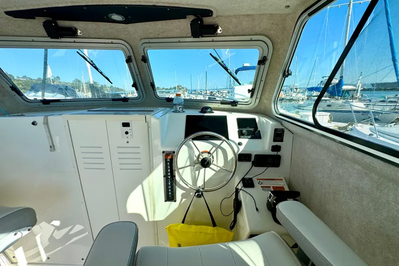Slide: The Image of Interior of 2021 Parker 2820 XLD Sport Cabin boat with steering wheel and dashboard. - 6