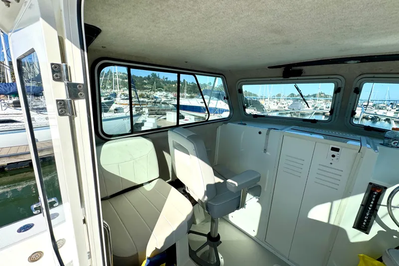 Slide: The Image of 2021 Parker 2820 XLD Sport Cabin interior with marina view through large windows. - 8