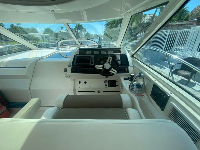 Slide: The Image of Helm of 2012 Sea Ray 450 Sundancer yacht with modern controls and panoramic view. - 11