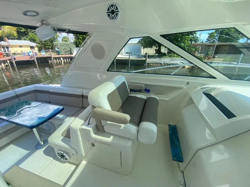 Slide: The Image of Interior of 2012 Sea Ray 450 Sundancer yacht with seating and table by the water. - 13