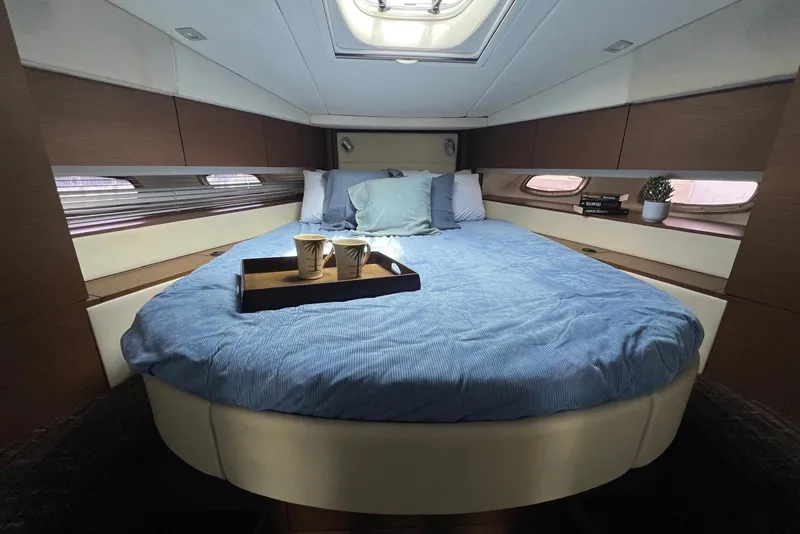 Slide: The Image of Luxurious cabin interior of 2012 Sea Ray 450 Sundancer with cozy bed and skylight. - 19