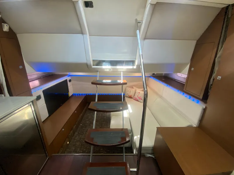 Slide: The Image of Luxurious interior of 2012 Sea Ray 450 Sundancer yacht with modern seating and ambient lighting. - 23