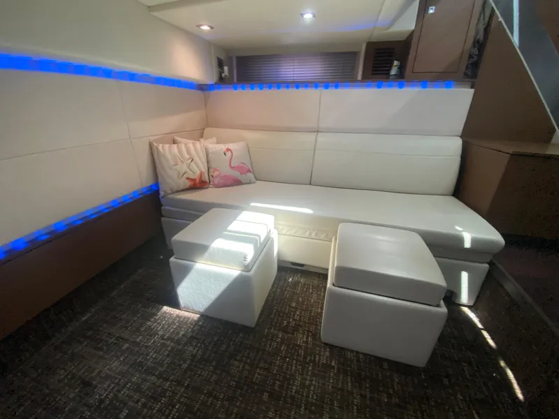 Slide: The Image of Luxurious interior of 2012 Sea Ray 450 Sundancer with white seating and ambient lighting. - 24