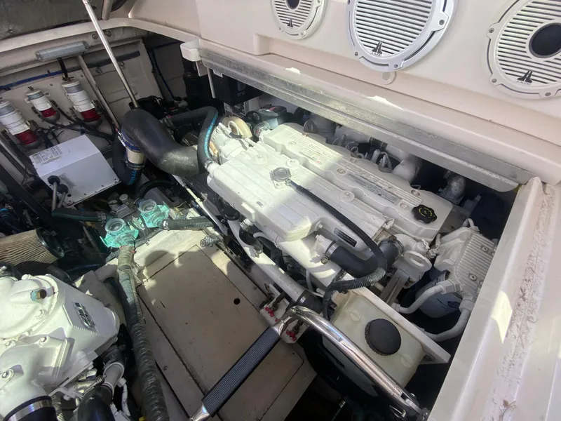 Slide: The Image of Engine compartment of a 2012 Sea Ray 450 Sundancer, showcasing mechanical components and systems. - 32