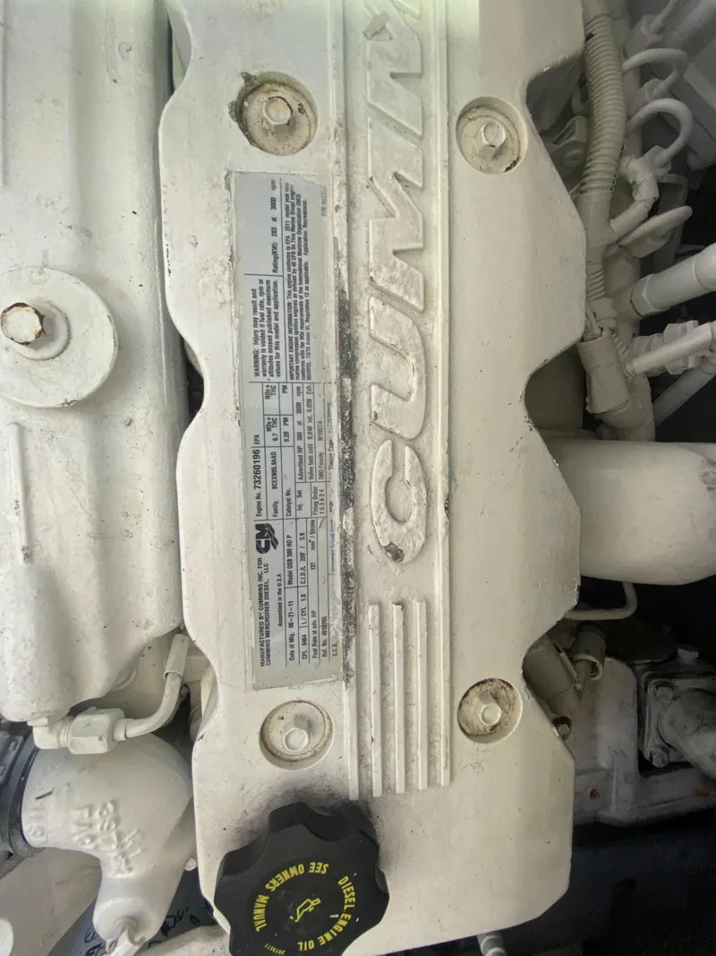 Slide: The Image of Engine of 2012 Sea Ray 450 Sundancer with Cummins branding and oil cap. - 33