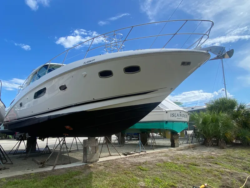 Slide: The Image of 2012 Sea Ray 450 Sundancer yacht on dry dock under a clear blue sky. - 42