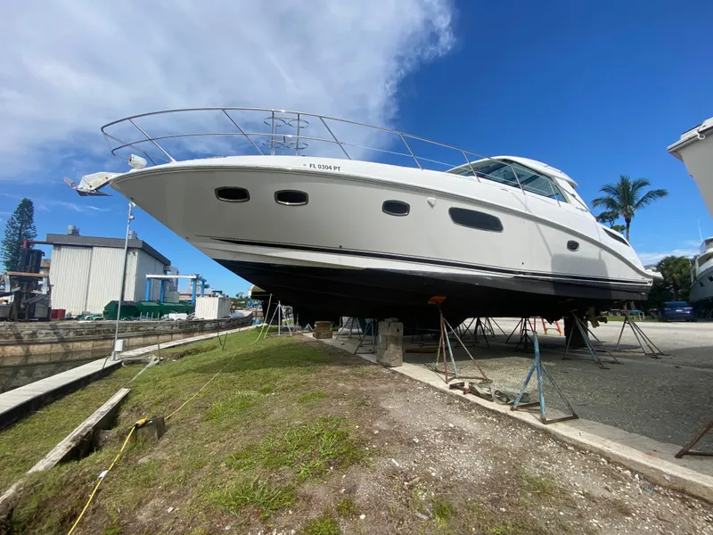 Slide: The Image of 2012 Sea Ray 450 Sundancer yacht on dry dock under clear blue sky. - 44