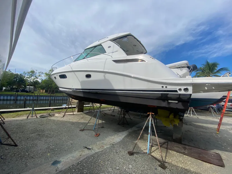 Slide: The Image of 2012 Sea Ray 450 Sundancer yacht on stands, under a partly cloudy sky. - 45