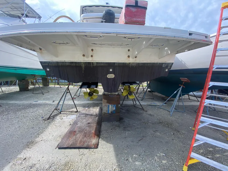 Slide: The Image of 2012 Sea Ray 450 Sundancer yacht on dry dock, showing propellers and hull. - 48