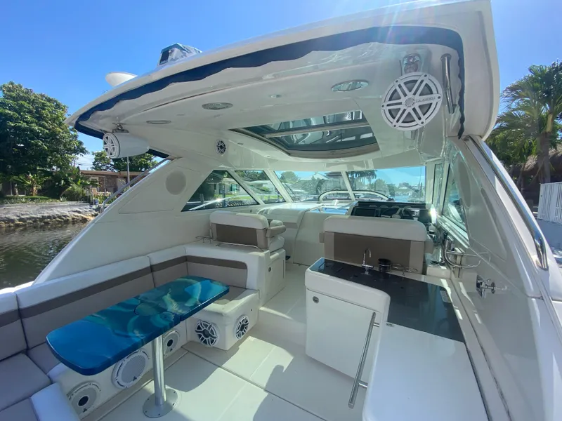 Slide: The Image of 2012 Sea Ray 450 Sundancer yacht interior with seating, table, and helm station. - 5
