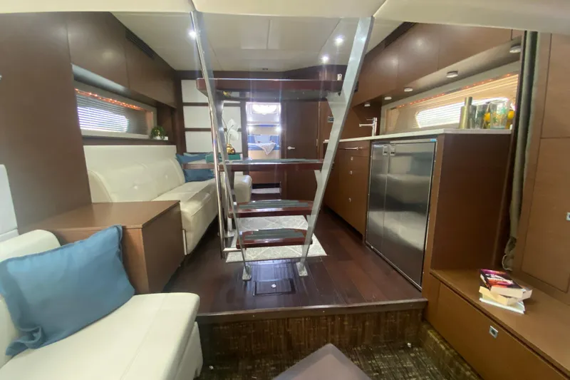 Slide: The Image of Luxurious interior of 2012 Sea Ray 450 Sundancer yacht with modern kitchen and seating area. - 52
