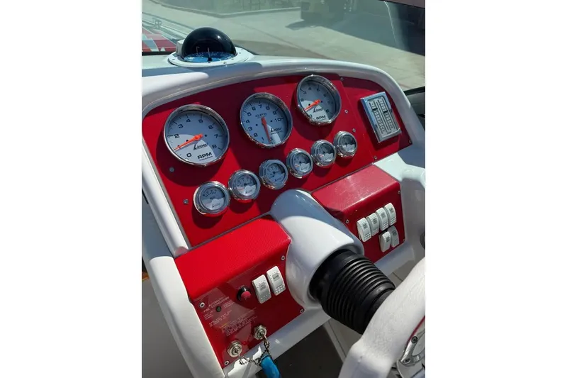 Slide: The Image of Dashboard of a 2007 Formula 353 FASTech boat with red and white gauges. - 10