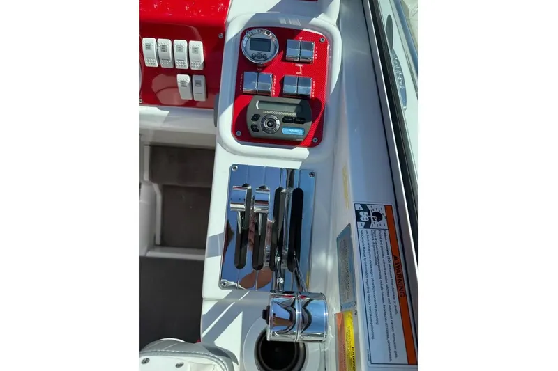 Slide: The Image of 2007 Formula 353 FASTech boat dashboard with controls and gauges in red and white. - 11