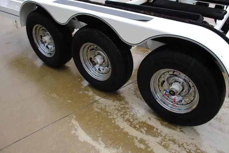 Slide: The Image of Triple-axle trailer for 2007 Formula 353 FASTech boat on wet pavement. - 25