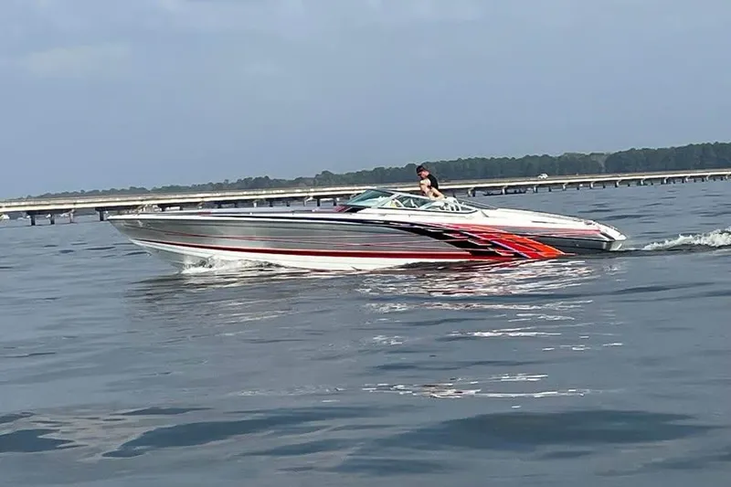 Slide: The Image of 2007 Formula 353 FASTech speedboat cruising on calm water with scenic background. - 3