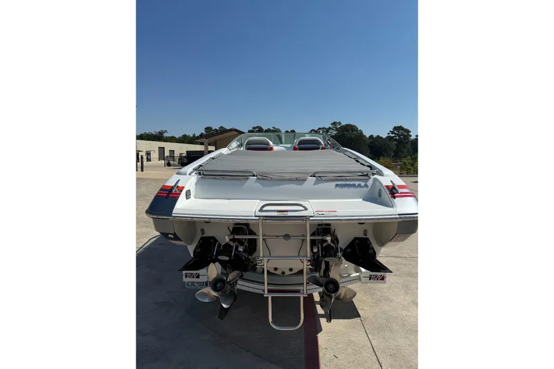 Slide: The Image of 2007 Formula 353 FASTech boat, rear view, parked outdoors on a sunny day. - 7