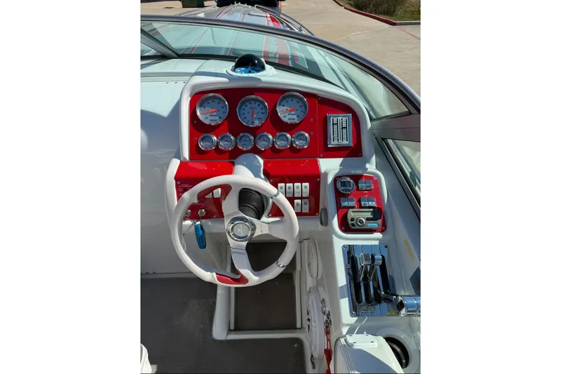 Slide: The Image of 2007 Formula 353 FASTech boat dashboard with red accents and multiple gauges. - 9