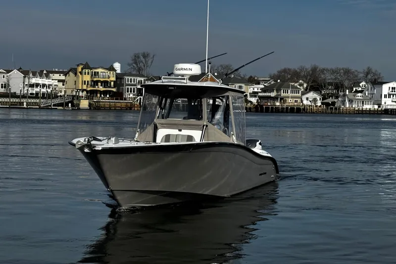 Slide: The Image of 2024 Cape Horn 32 T boat on calm water near residential shoreline. - 1