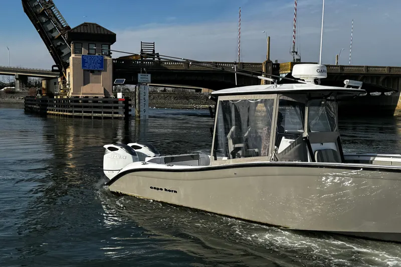 Slide: The Image of 2024 Cape Horn 32 T boat navigating near a raised drawbridge on a sunny day. - 5