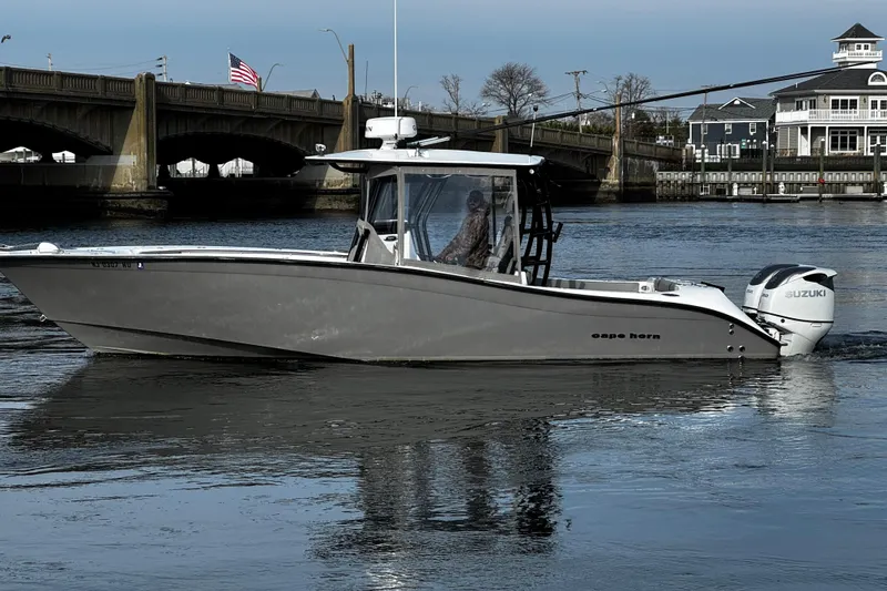 The Image of 2024 Cape Horn 32 T boat cruising near a bridge with Suzuki engines. - 0