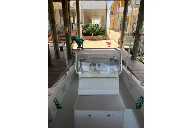 Slide: The Image of 2002 Regulator 23 Classic boat docked in a covered marina. - 10