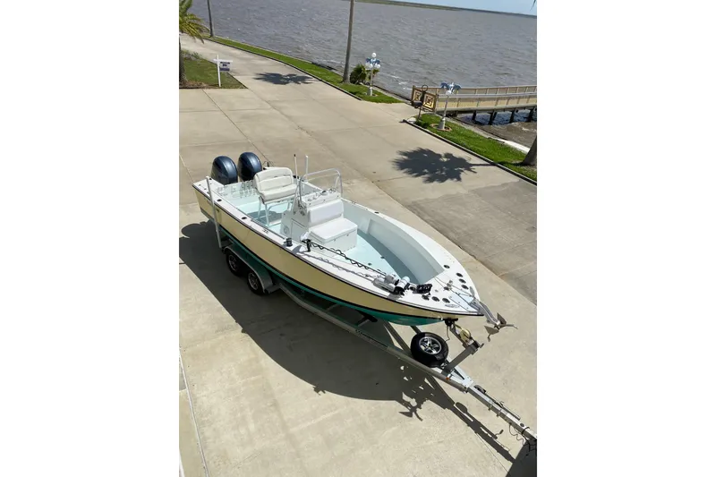 Slide: The Image of 2002 Regulator 23 Classic boat on trailer by waterfront. - 3
