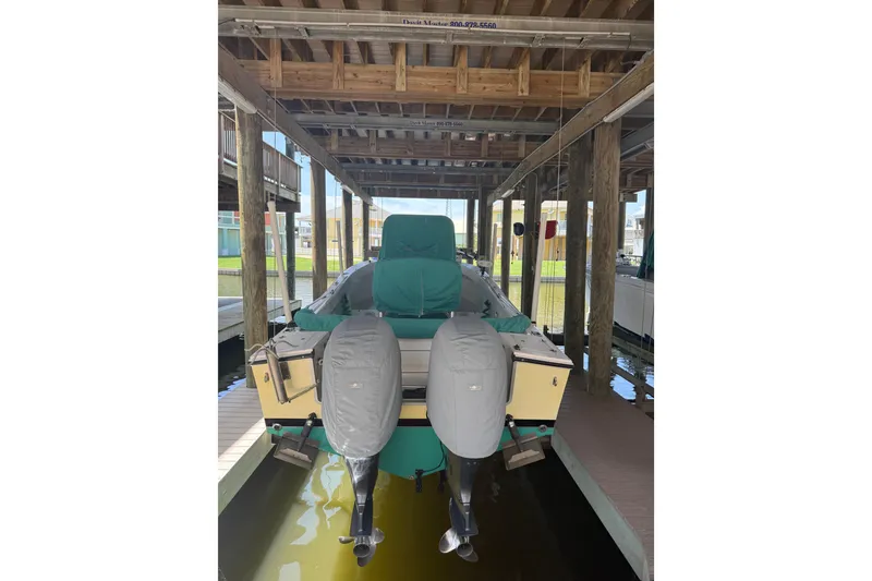 Slide: The Image of 2002 Regulator 23 Classic boat on trailer, parked near a house. - 4