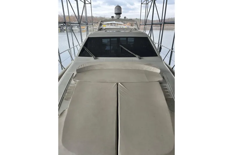 Slide: The Image of 2006 Azimut 68S yacht docked, featuring sleek design and spacious deck. - 10