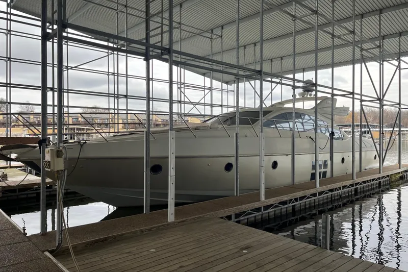 Slide: The Image of 2006 Azimut 68S yacht docked under a covered marina. - 3