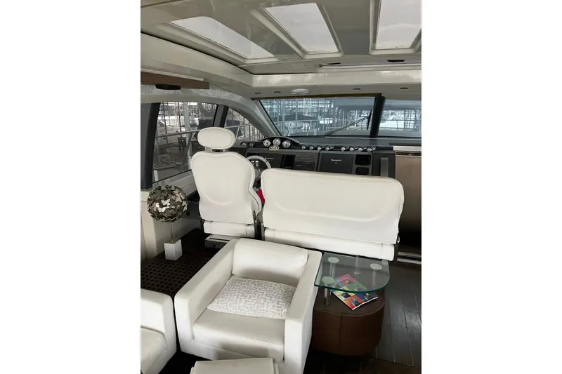 Slide: The Image of Luxurious interior of a 2006 Azimut 68S yacht with white seating and modern helm. - 8
