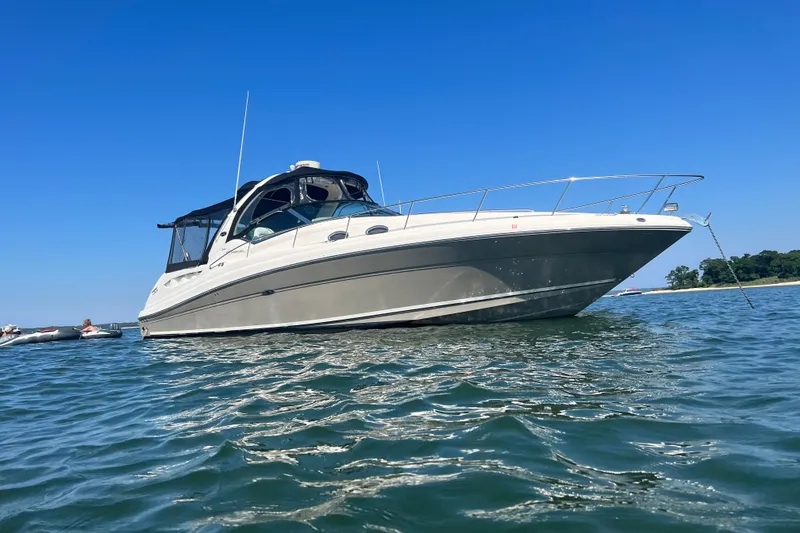 Slide: The Image of 2007 Sea Ray 340 Sundancer yacht on calm water under clear blue sky. - 2