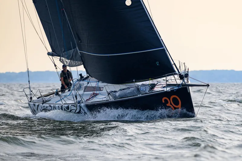 Slide: The Image of Sailing yacht Class 40 Akilaria 2007 navigating through waves, showcasing sleek design and performance. - 10