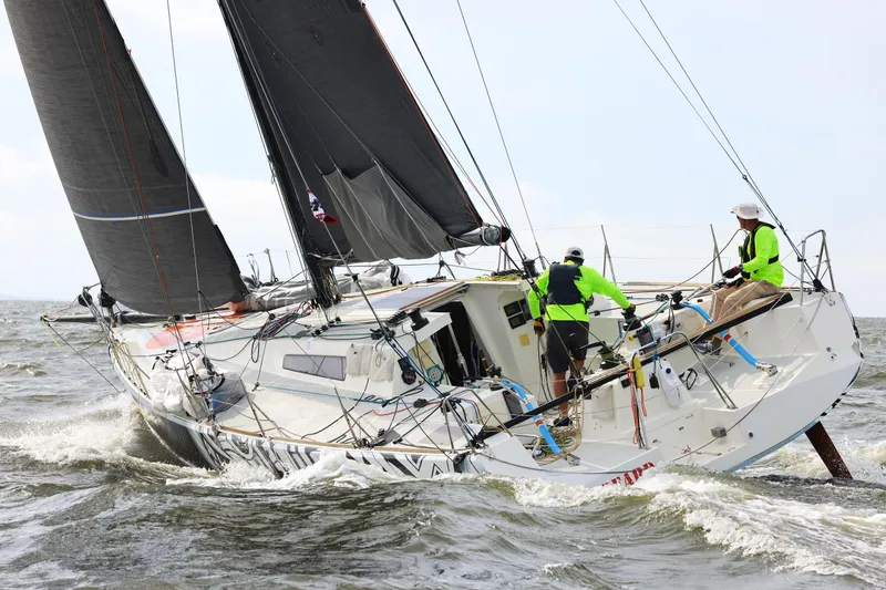 Slide: The Image of Sailors navigating 2007 Class 40 Akilaria yacht in choppy waters. - 3