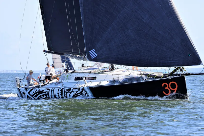 Slide: The Image of Sailing yacht Class 40 Akilaria 2007 with striking black sails and hull design. - 4