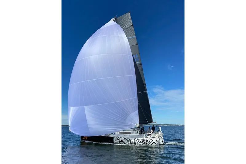 Slide: The Image of Sailing yacht Class 40 Akilaria 2007 with large white spinnaker on open water. - 5