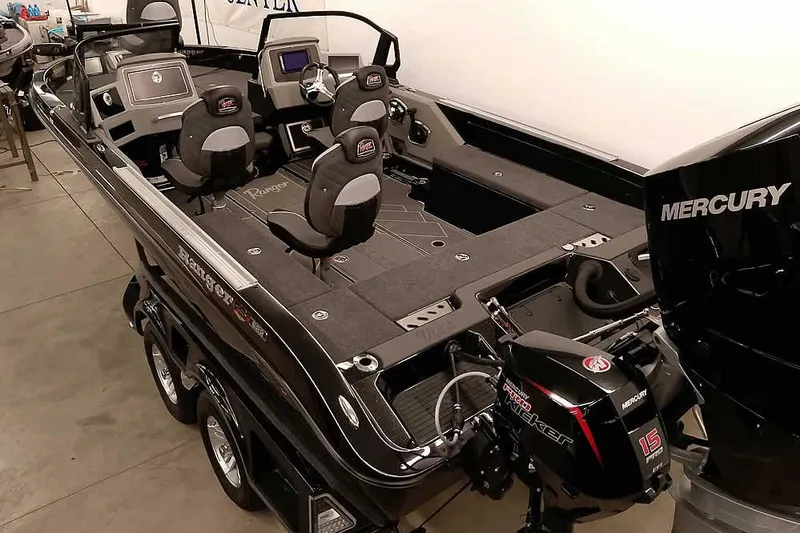 Slide: The Image of 2026 Ranger 622FS Pro fishing boat with Mercury outboard motor in showroom. - 11