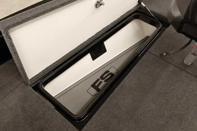 Slide: The Image of 2026 Ranger 622FS Pro boat storage compartment with secure latch and carpeted interior. - 17