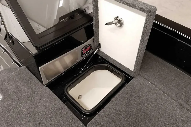 Slide: The Image of 2026 Ranger 622FS Pro boat storage compartment with open lid and secure lock. - 18