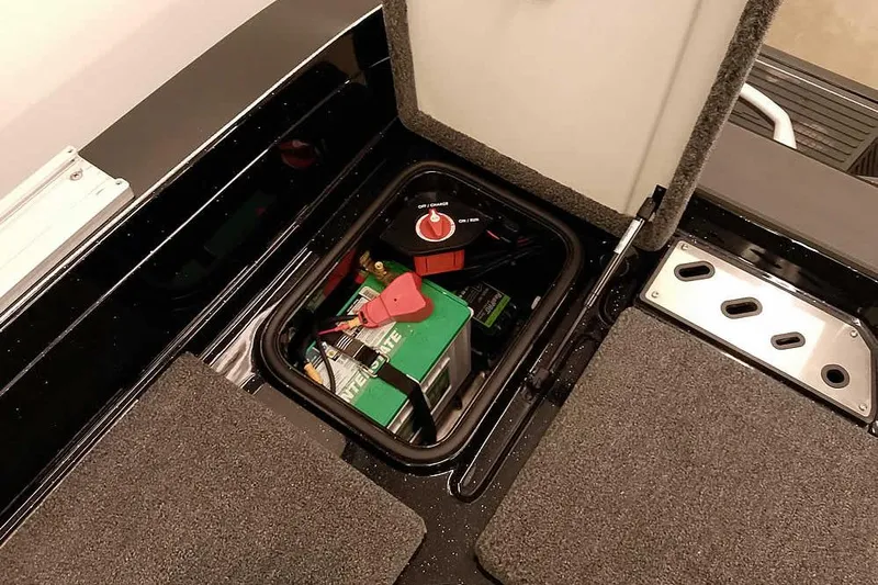 Slide: The Image of Open battery compartment in 2026 Ranger 622FS Pro boat, showing battery and switch. - 37