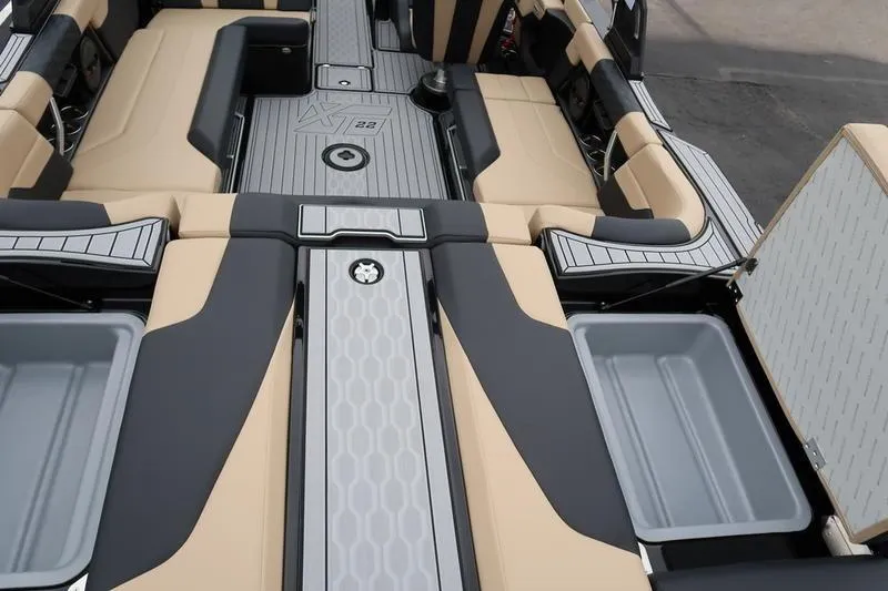 Slide: The Image of 2025 MasterCraft XT22 boat interior with sleek seating and storage compartments. - 14