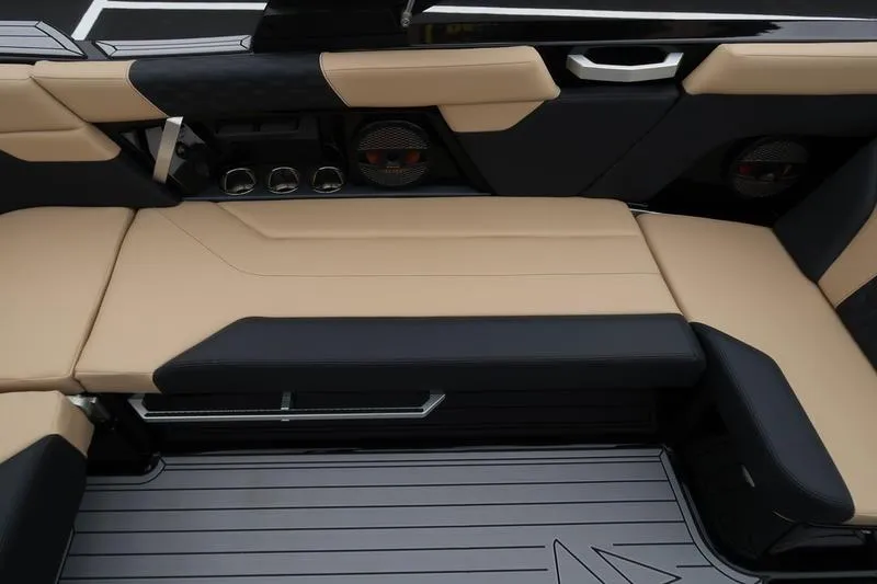 Slide: The Image of 2025 MasterCraft XT22 interior with beige and black seating, modern design, and integrated speakers. - 19