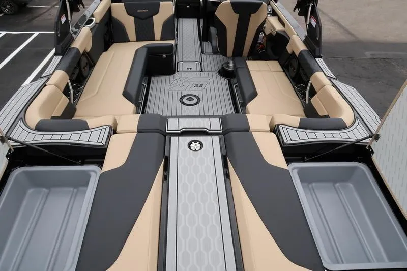 Slide: The Image of 2025 MasterCraft XT22 boat interior with beige and black seating, modern design. - 25