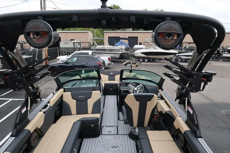 Slide: The Image of 2025 MasterCraft XT22 boat interior with premium seating and advanced audio system. - 30