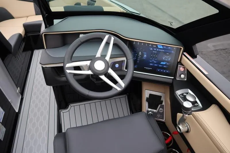 Slide: The Image of 2025 MasterCraft XT22 boat dashboard with modern steering and digital display. - 38
