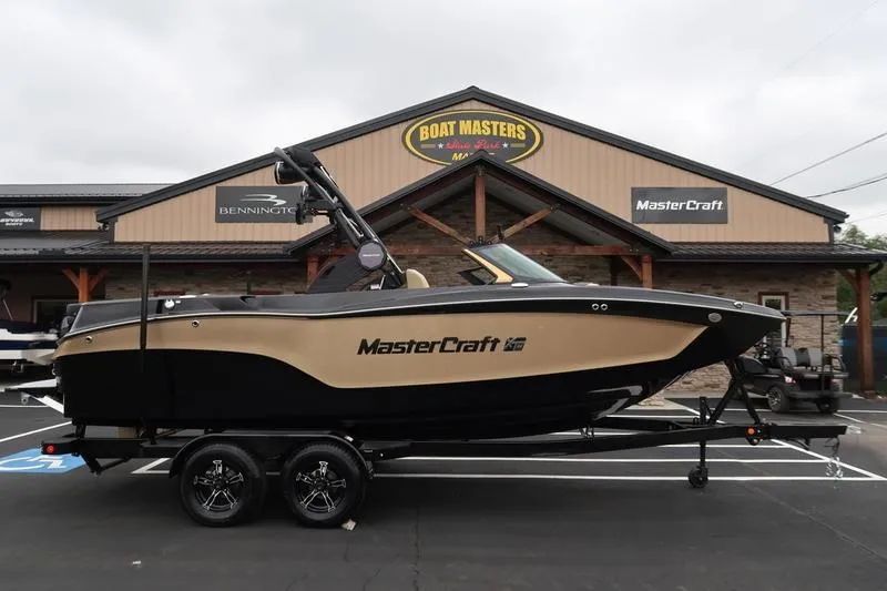Slide: The Image of 2025 MasterCraft XT22 boat on trailer at dealership, Boat Masters sign in background. - 4