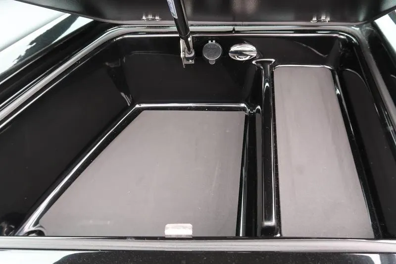 Slide: The Image of 2025 MasterCraft XT22 storage compartment with sleek black interior design. - 42